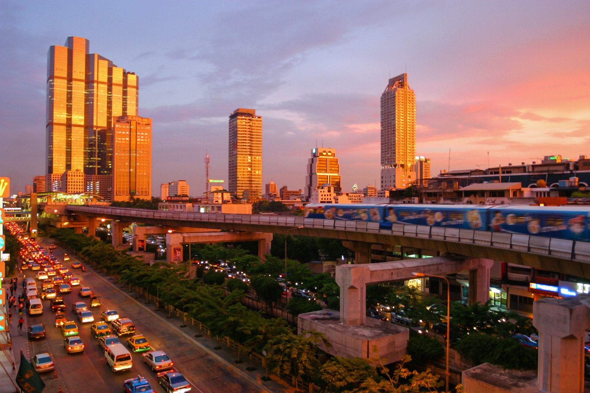 Bangkok BTS Skytrain elevated rail transit winding through modern skyscrapers