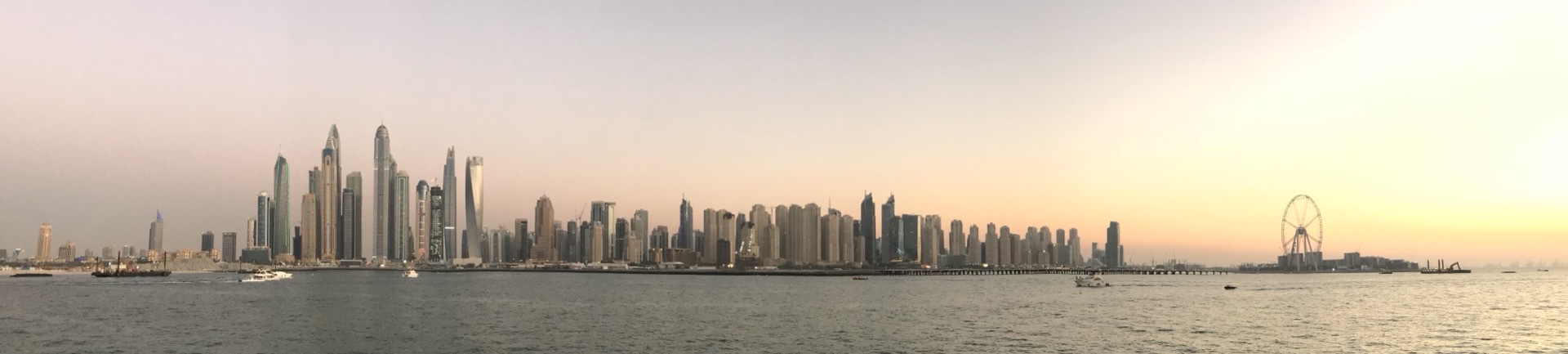 Dubai Skyline across the water at dusk with modern skyscrapers