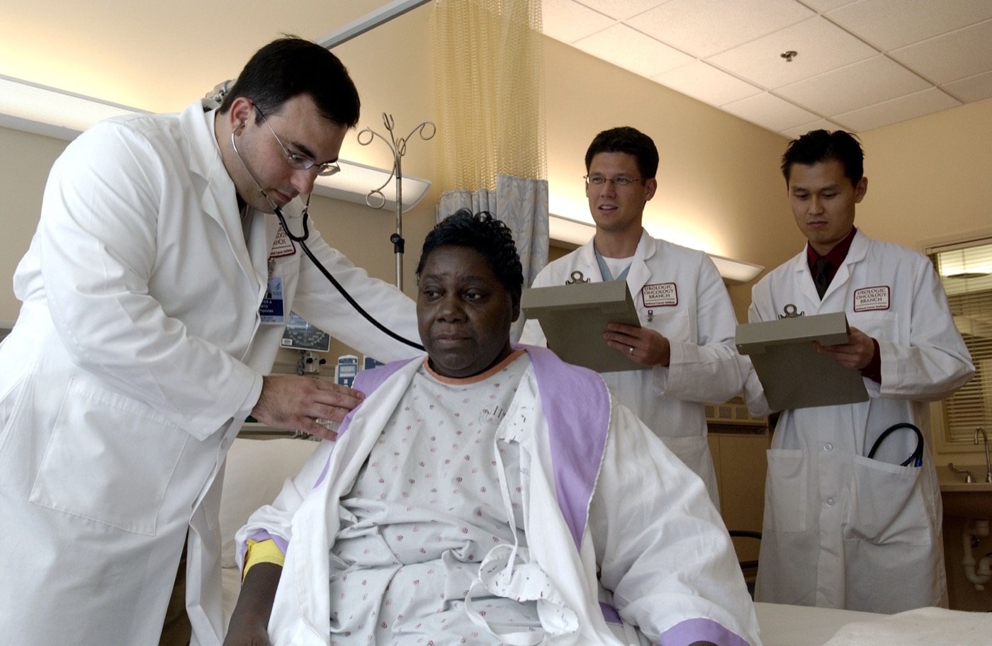 Doctor examining patient in hospital room